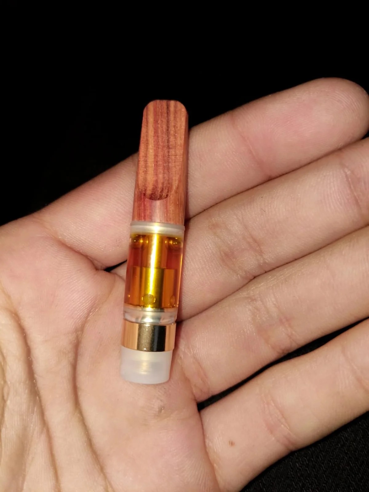 A high potency 5-MeO-DMT vape pen resting on a dark surface, representing where to buy high potency 5-MeO-DMT vape pens in Toronto.